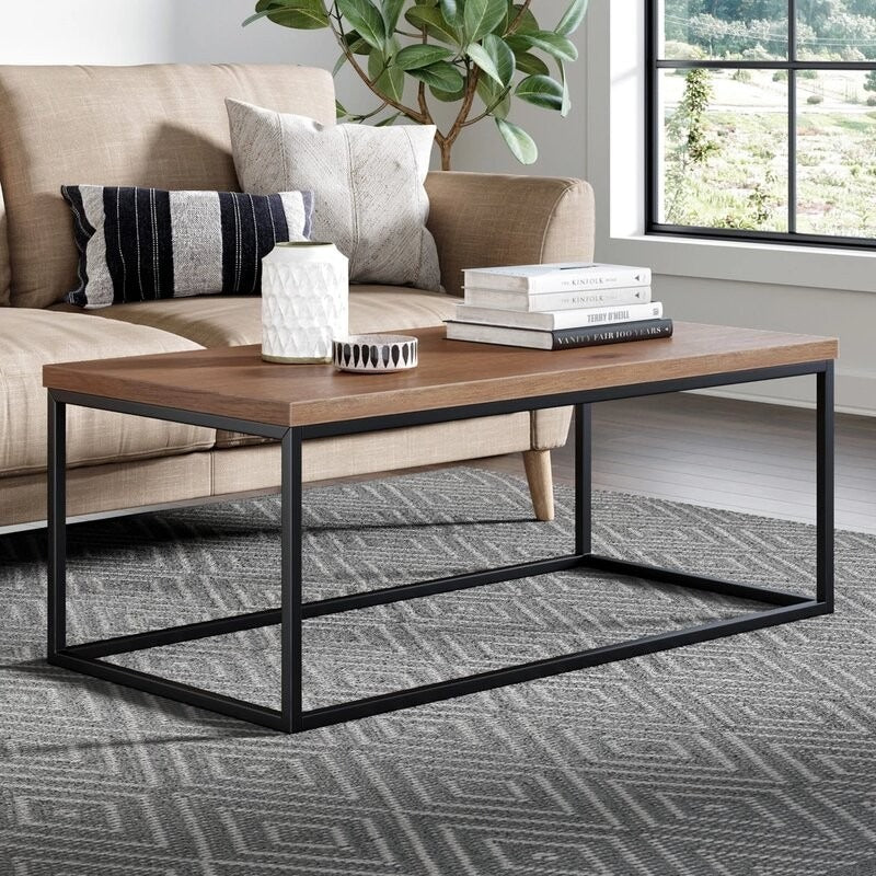 Black matte metal frame supporting Sheesham wood rectangular coffee table