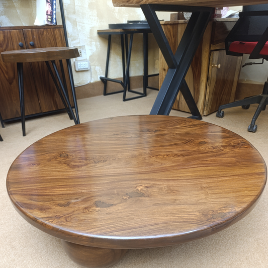 Top view of round sheesham wood coffee table with natural wood grain