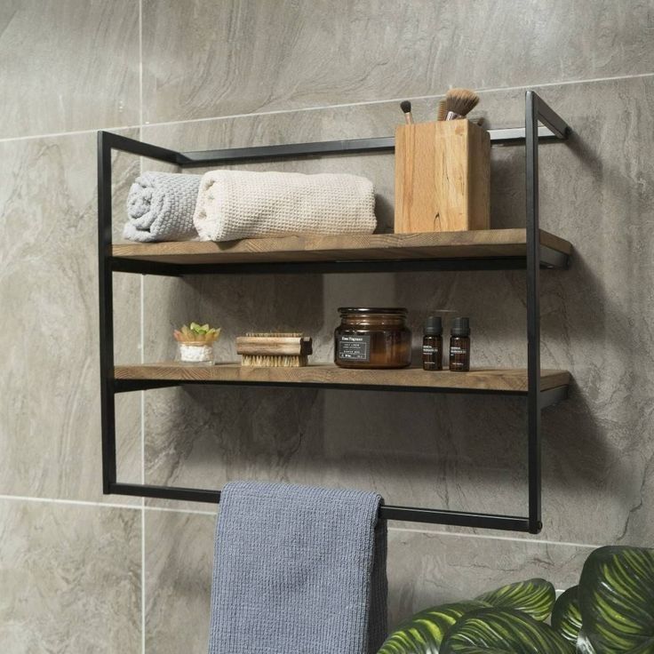 Bathroom shelf with towels and toiletries against a tiled wall