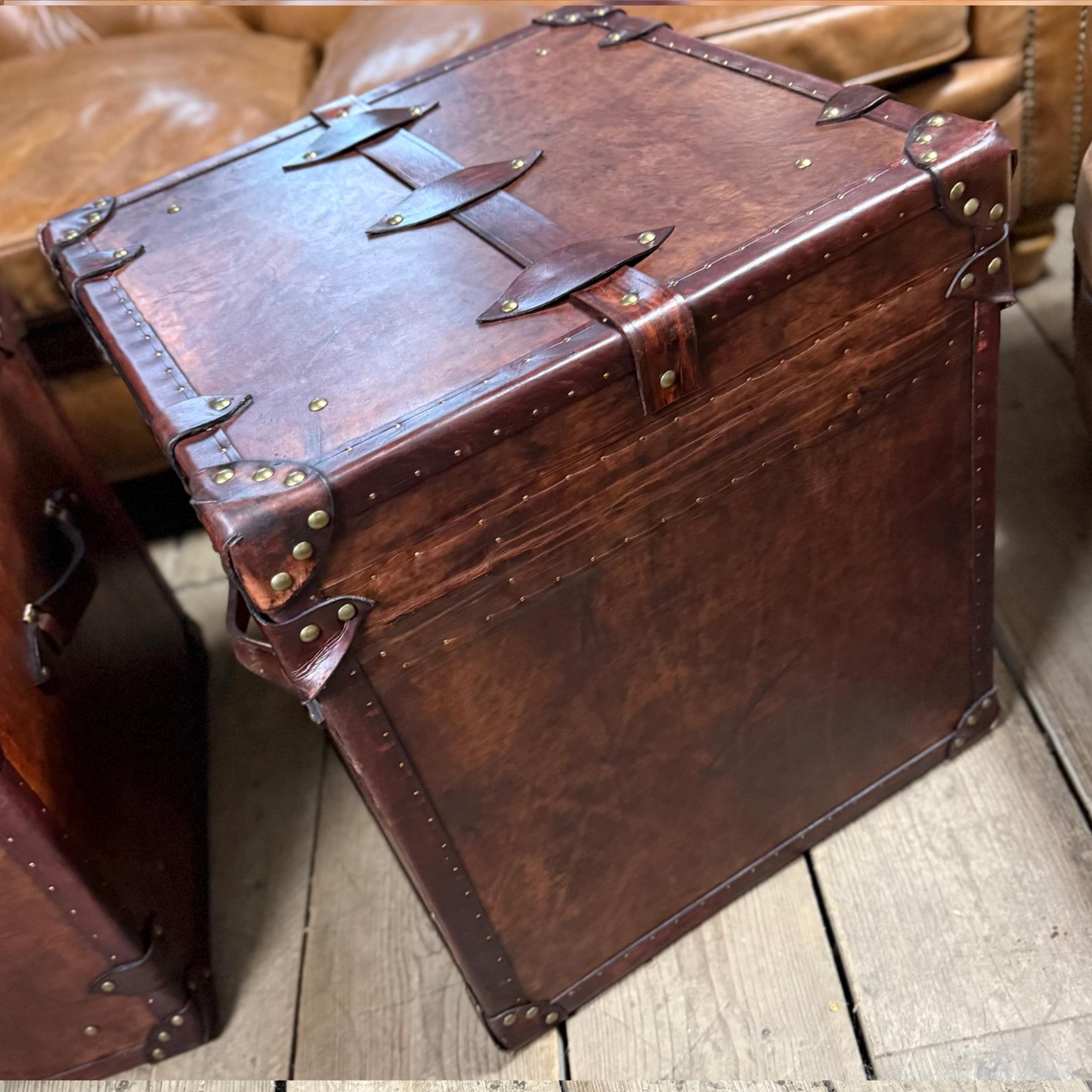 Vintage-style leather suitcase on a wooden floor