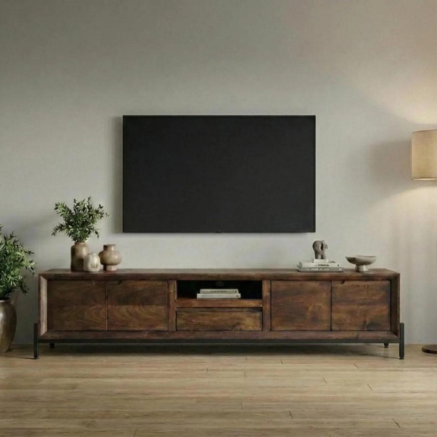 Wooden TV stand with a large flat-screen TV mounted on a wall in a living room.