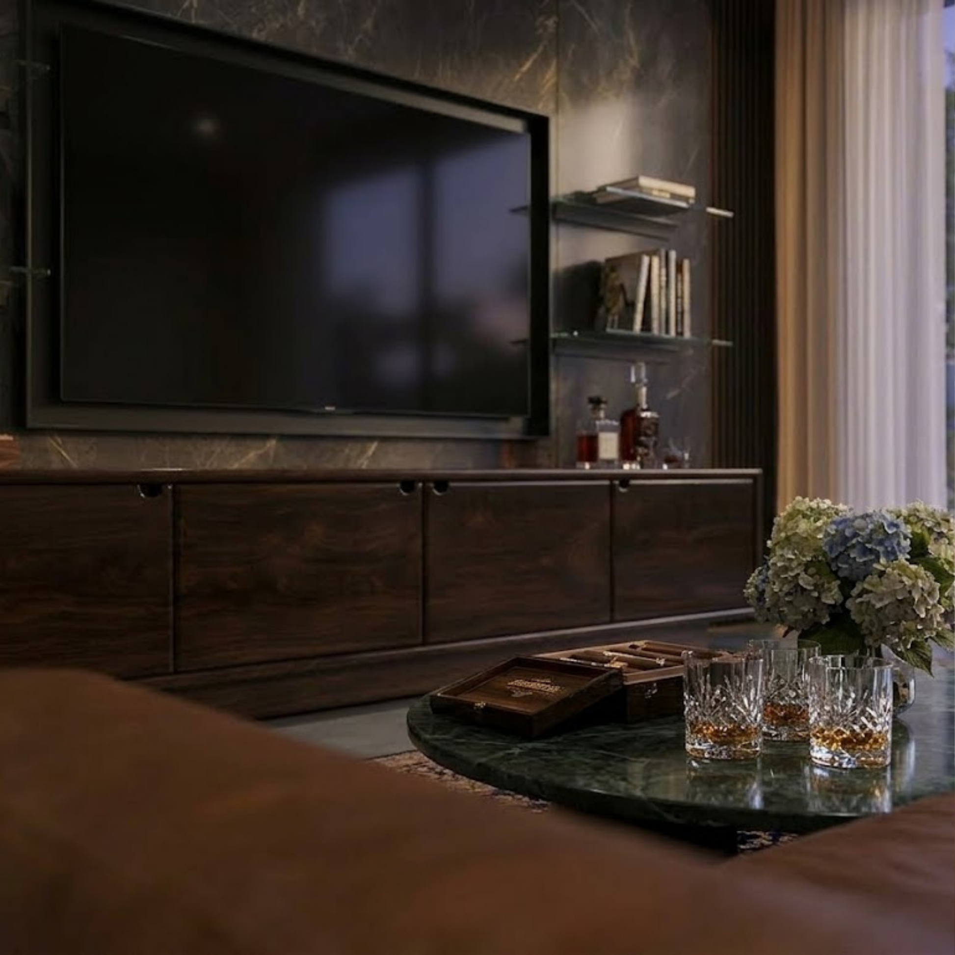 Living room with a television, drinks on a table, and decorative elements.