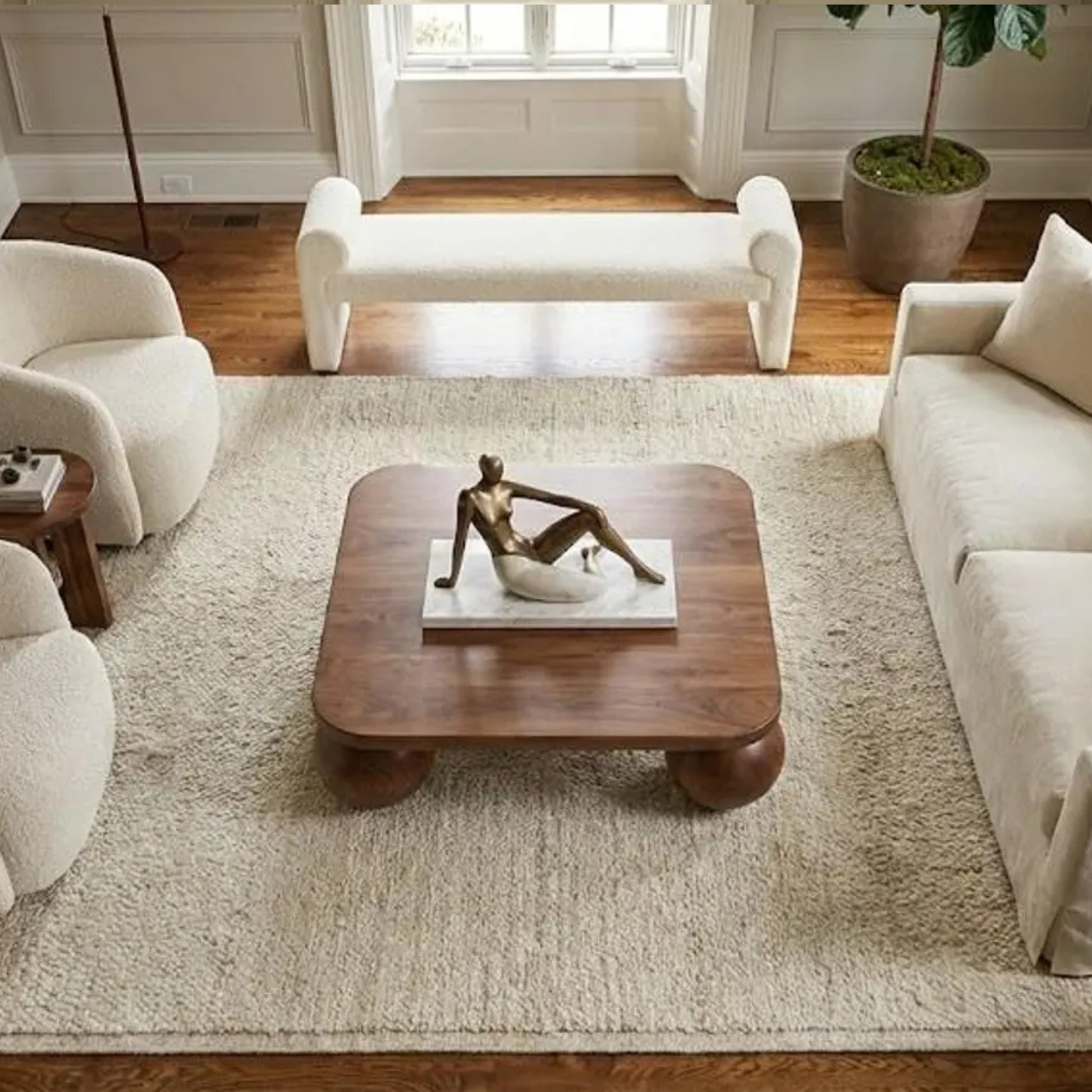 Modern low wooden coffee table with sculptural ball legs