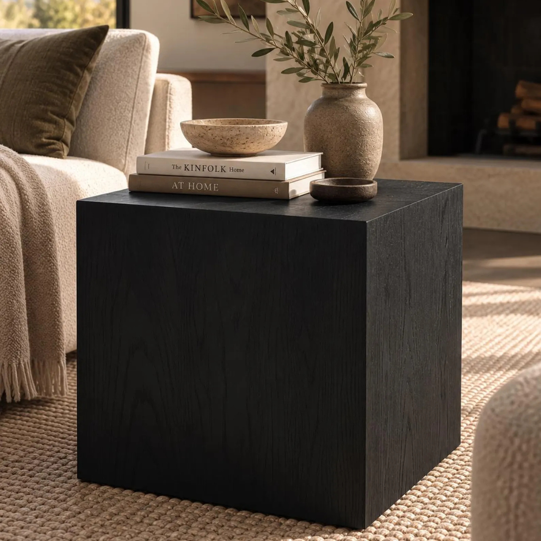 Solid wood cube end table beside a living room sofa