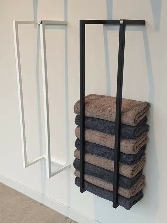 Towel rack with folded towels against a striped wall.