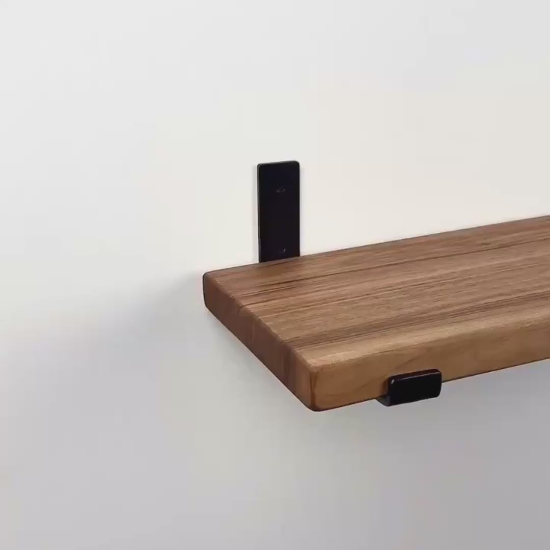Solid Sheesham wood floating wall shelves with heavy-duty industrial steel brackets by Adaptivo Furniture.