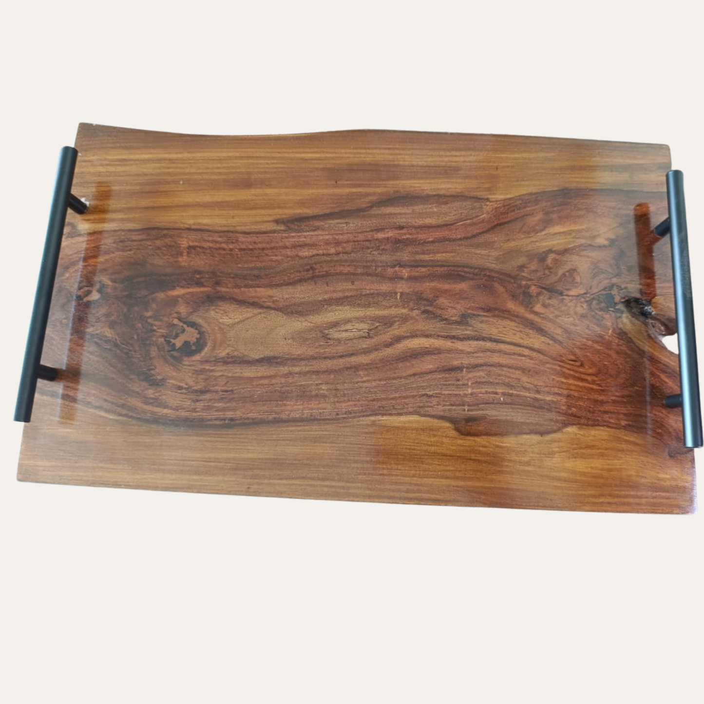 Close-up of Sheesham wood texture and smooth live edge on cutting board with handle