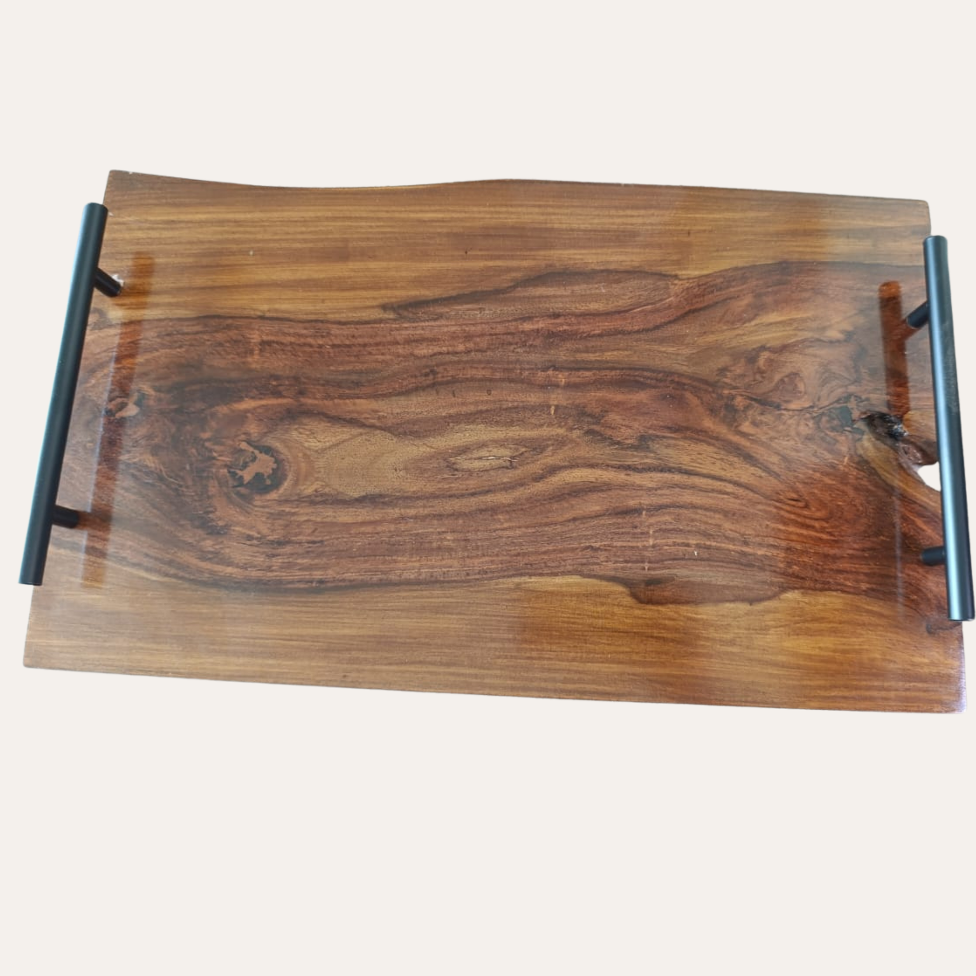 Close-up of Sheesham wood texture and smooth live edge on cutting board with handle