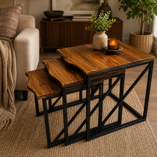 Three nested square nesting tables with warm medium-brown wood tops and black metal crisscross frames, styled in a cozy living room setting.